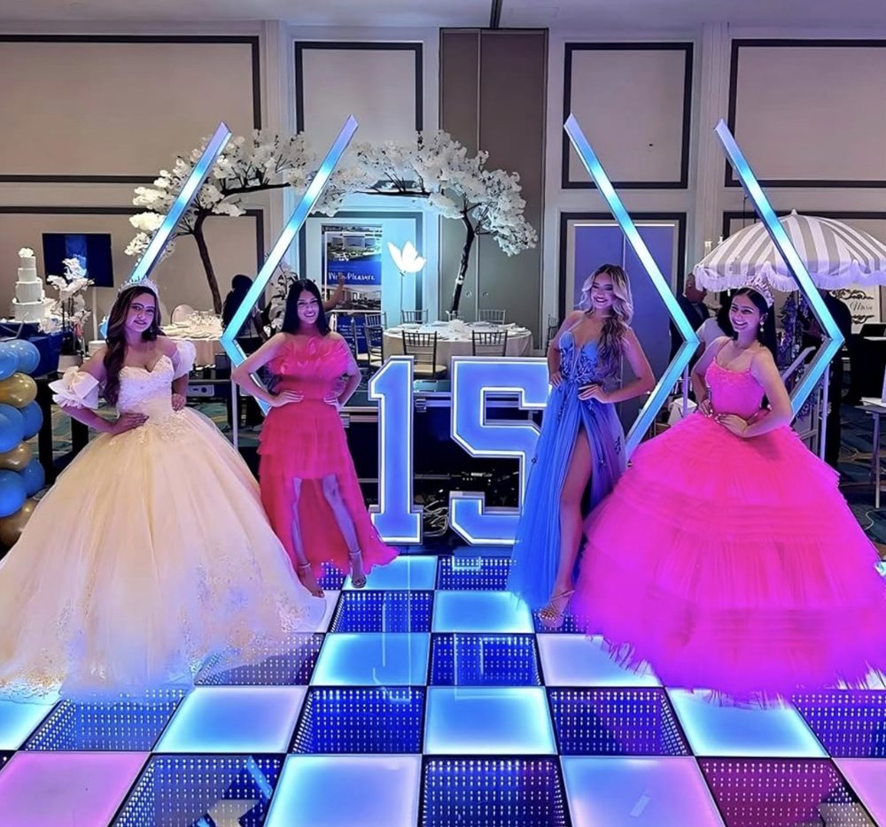 Guests posing on a lit 8x8 infinity RGB dance floor